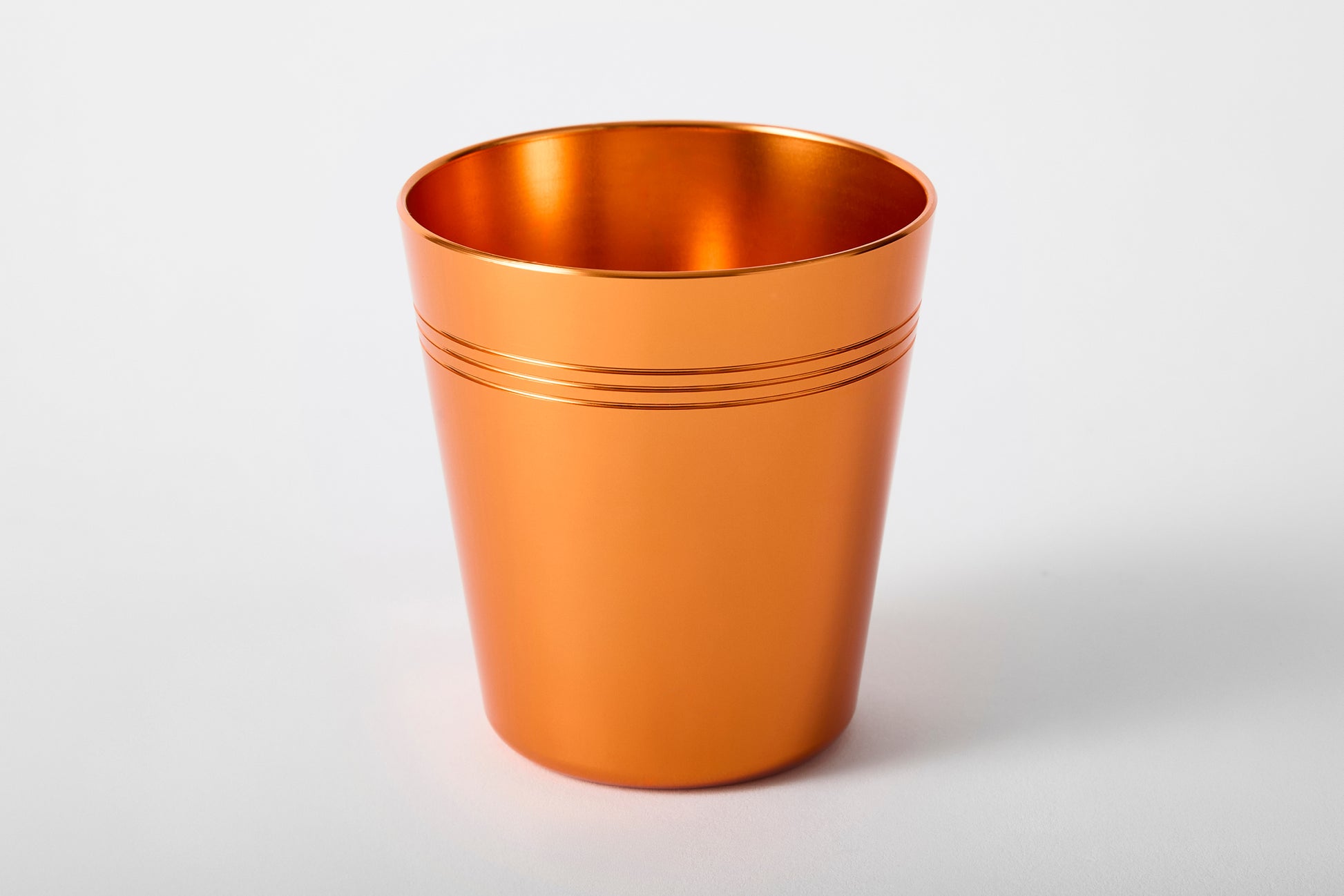 Single anodised aluminium cup in vibrant orange – colourful retro drinkware by Maits