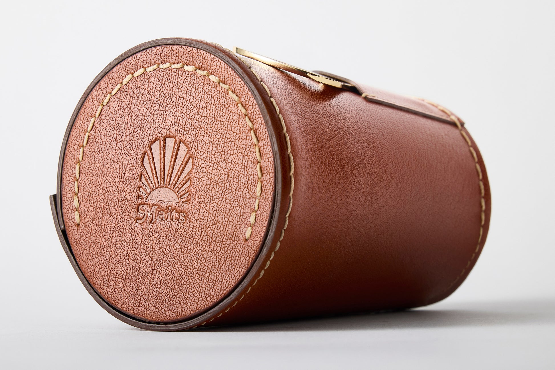 Close-up of Maits logo on premium leather case base – part of anodised cup set